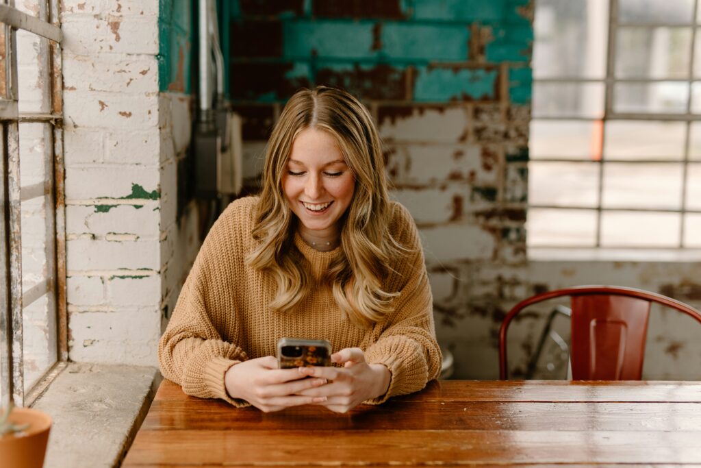Person checking their credit score on smartphone with relieved expression
