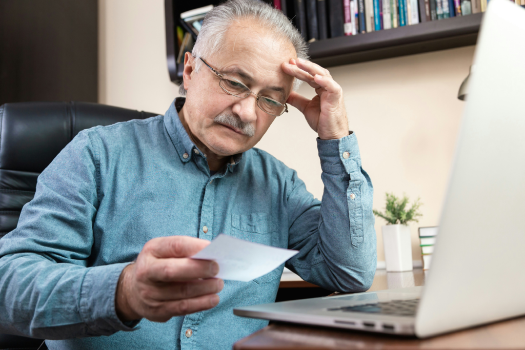 person reading credit card rejection letter with disappointed expression.webp
