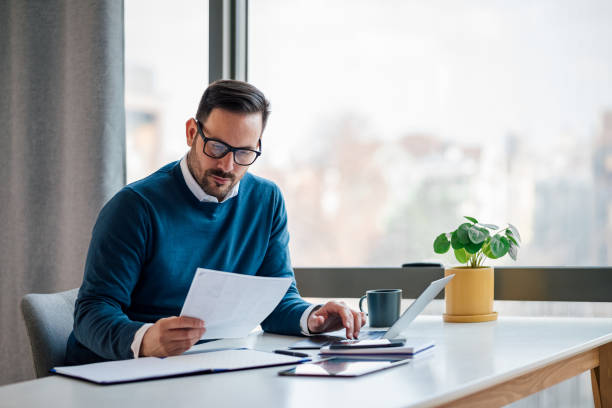 person reviewing a collection letter bills and paperwork.webp
