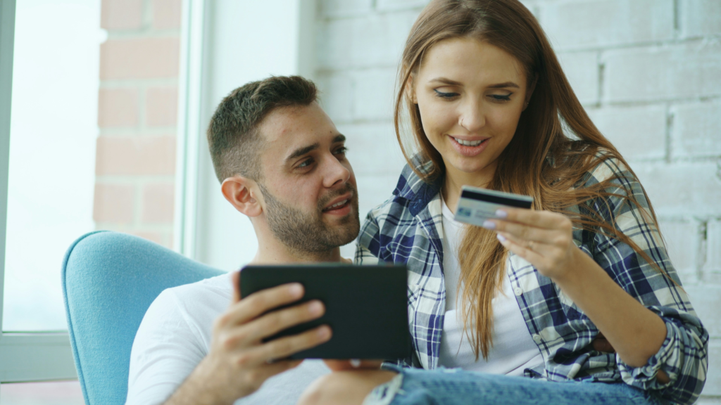 Young person holding their first credit card ready to start building credit history